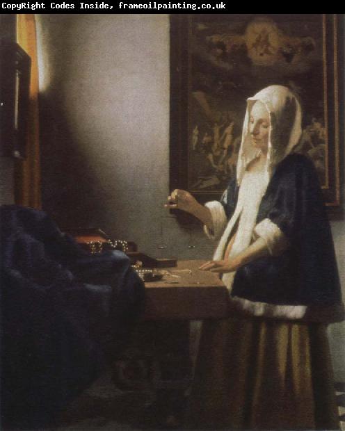 Jan Vermeer woman holding a balance